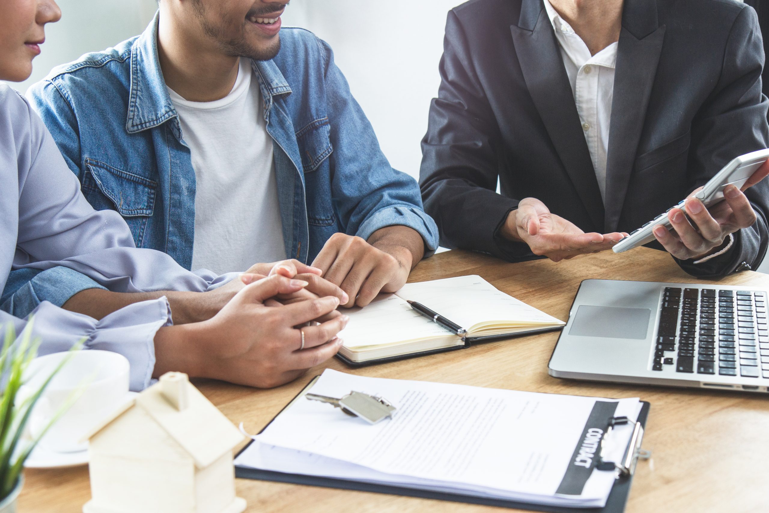 new house / home moving and relocation concept. Happy asian couple talking with apartment landlord from real estate agent / realtor.